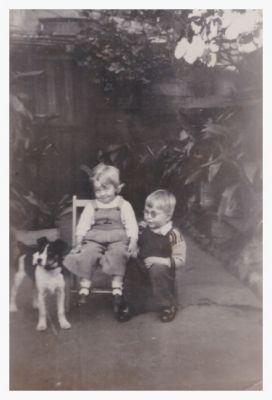 1948 Lois and Neil with their dog Spot in the backyard of their grandmother Maud's house in Nicholson St

