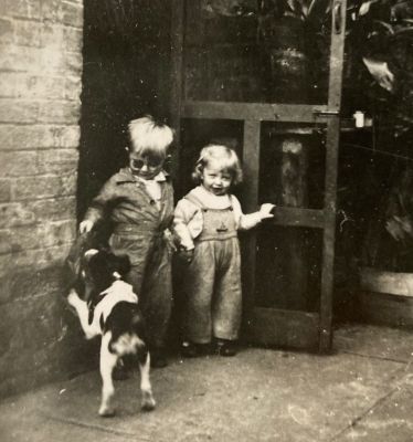 1948 Lois and Neil at their grandmother's house with their dog Spot
