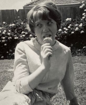 1966 Lois enjoying an ice cream in the backyard at Queens Parade
