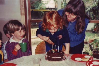 1992-01-04 Lois holds nephew Tom as he blows out the candles on his third birthday, while Matthew looks on
