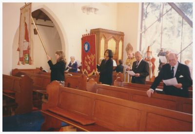 1996 Lois carriers the banner for the St Linus Day Celebration at the church
